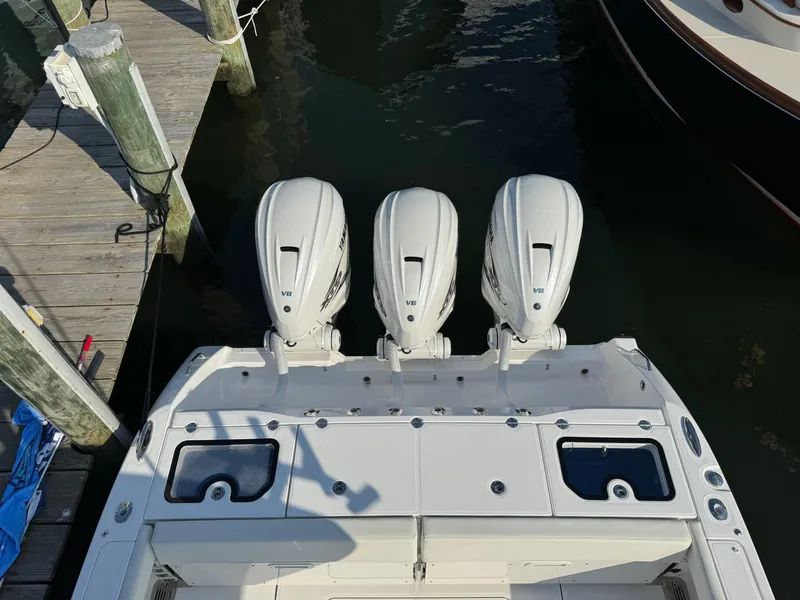 Slide: The Image of 2024 Everglades 395 Center Console with triple outboard engines at dock. - 15