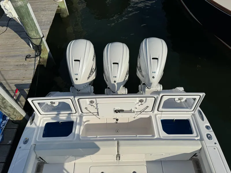 Slide: The Image of 2024 Everglades 395 Center Console boat with triple outboard engines at dock. - 16