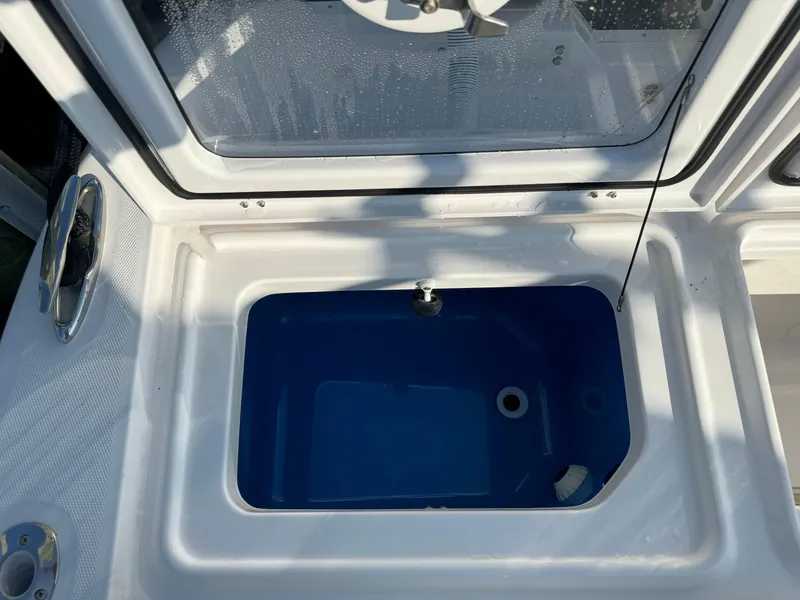 Slide: The Image of Livewell on 2024 Everglades 395 Center Console boat, open lid view. - 17