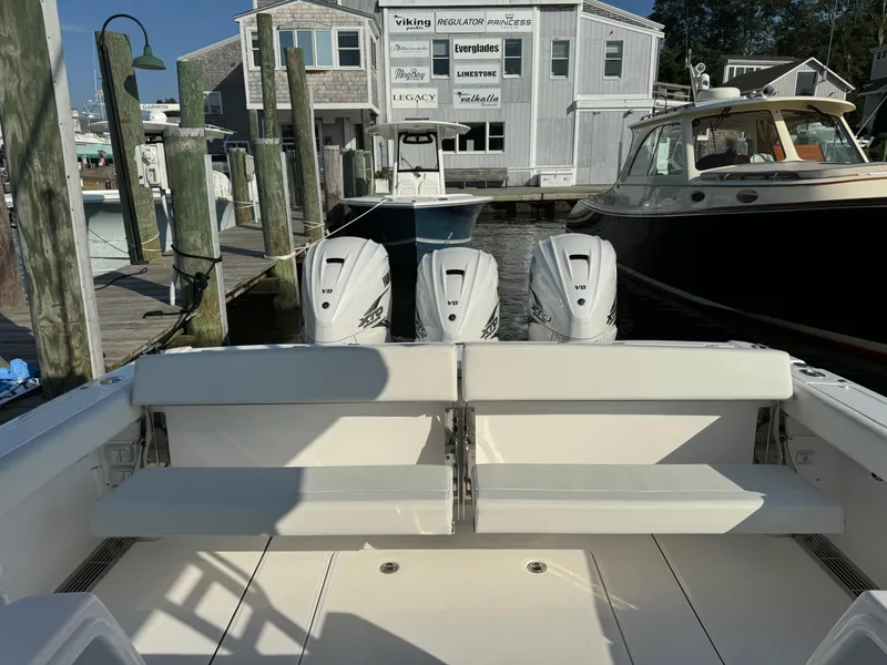 Slide: The Image of 2024 Everglades 395 Center Console boat with triple engines docked at marina. - 21