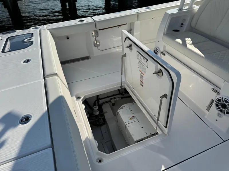 Slide: The Image of 2024 Everglades 395 Center Console boat with open storage compartment. - 24