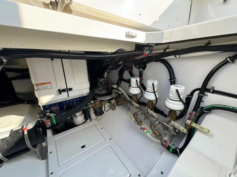 Slide: The Image of 2024 Everglades 395 Center Console engine compartment with advanced filtration system and wiring. - 26