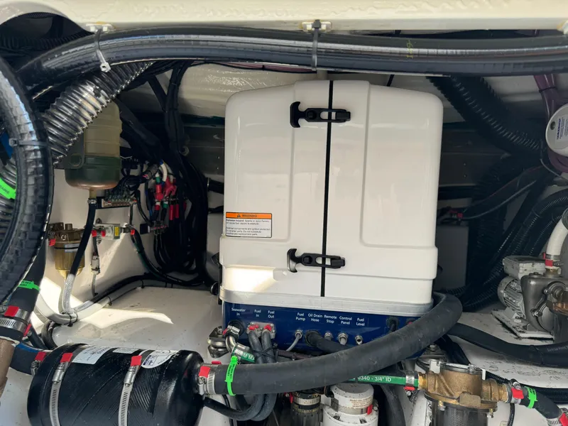 Slide: The Image of Engine compartment of 2024 Everglades 395 Center Console with various mechanical components. - 28