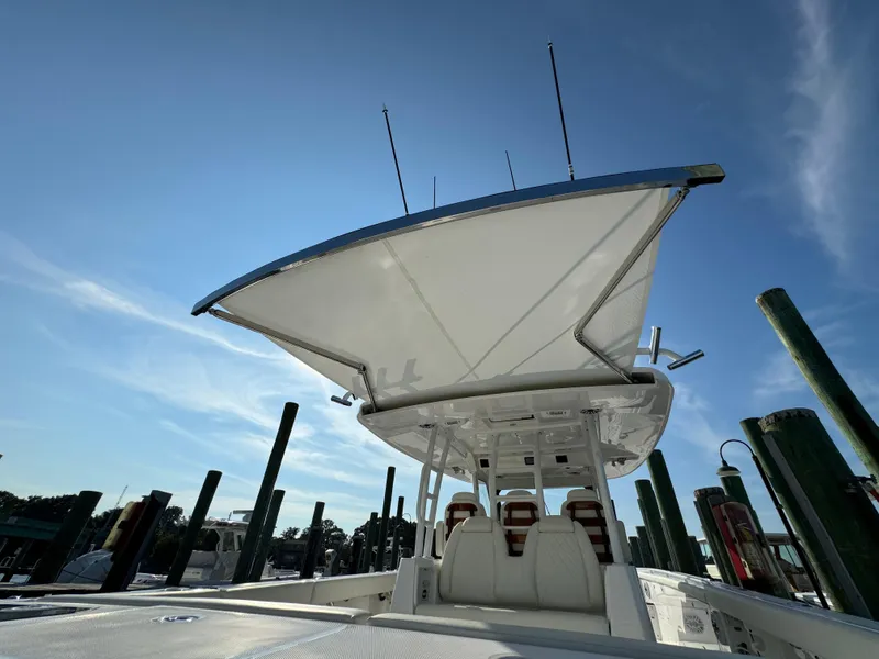Slide: The Image of 2024 Everglades 395 Center Console boat docked under clear blue sky. - 36