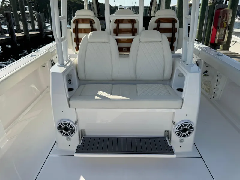 Slide: The Image of 2024 Everglades 395 Center Console boat interior with white seating and speakers. - 39
