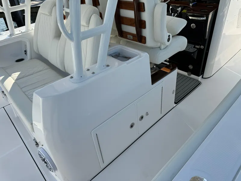 Slide: The Image of 2024 Everglades 395 Center Console interior with white seating and storage compartments. - 41