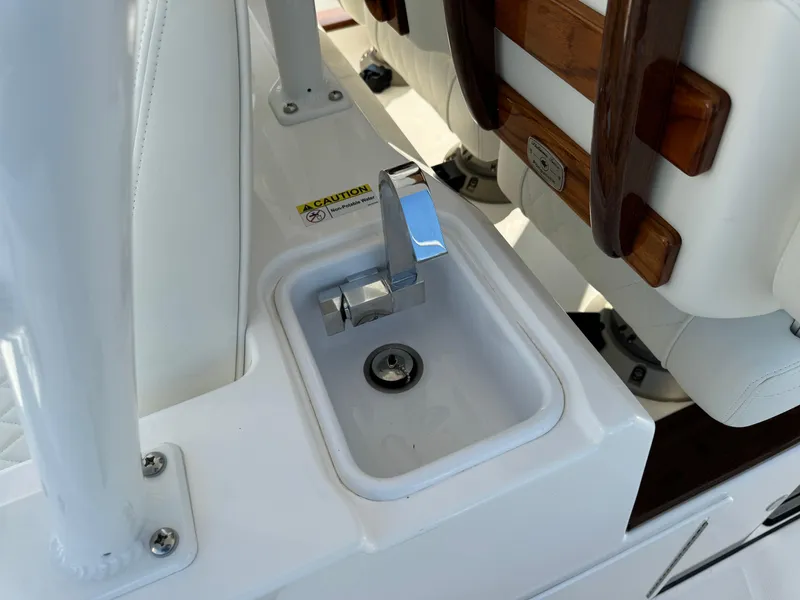 Slide: The Image of 2024 Everglades 395 Center Console boat sink with chrome faucet. - 42