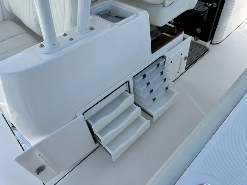 Slide: The Image of 2024 Everglades 395 Center Console boat storage compartments and seating area. - 43