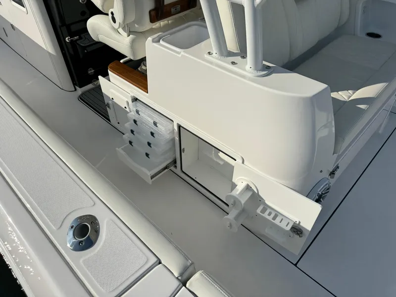 Slide: The Image of 2024 Everglades 395 Center Console boat interior with storage compartments and seating. - 44