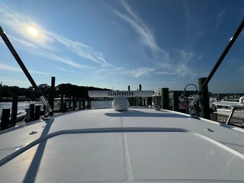 Slide: The Image of 2024 Everglades 395 Center Console boat with Garmin equipment, docked under a sunny sky. - 48