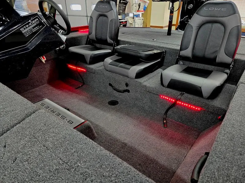 Slide: The Image of 2023 Lowe Stinger 188 boat interior with two seats and red LED lighting. - 18