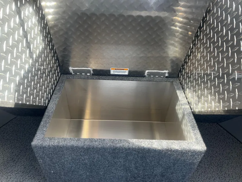 Slide: The Image of 2023 Thunder Jet 21 Chinook OS storage compartment with diamond plate interior. - 12