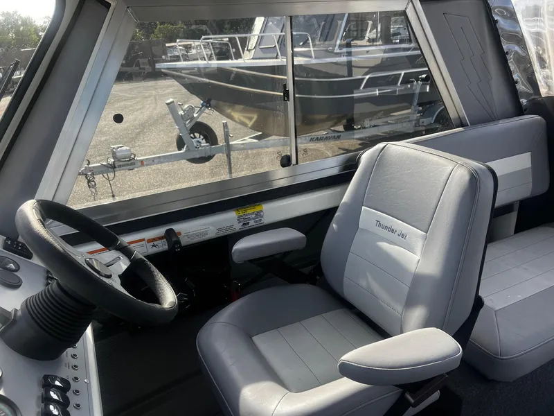 Slide: The Image of 2023 Thunder Jet 21 Chinook OS boat interior with steering wheel and seating. - 15