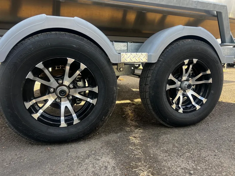 Slide: The Image of 2023 Thunder Jet 21 Chinook OS trailer wheels on asphalt. - 25