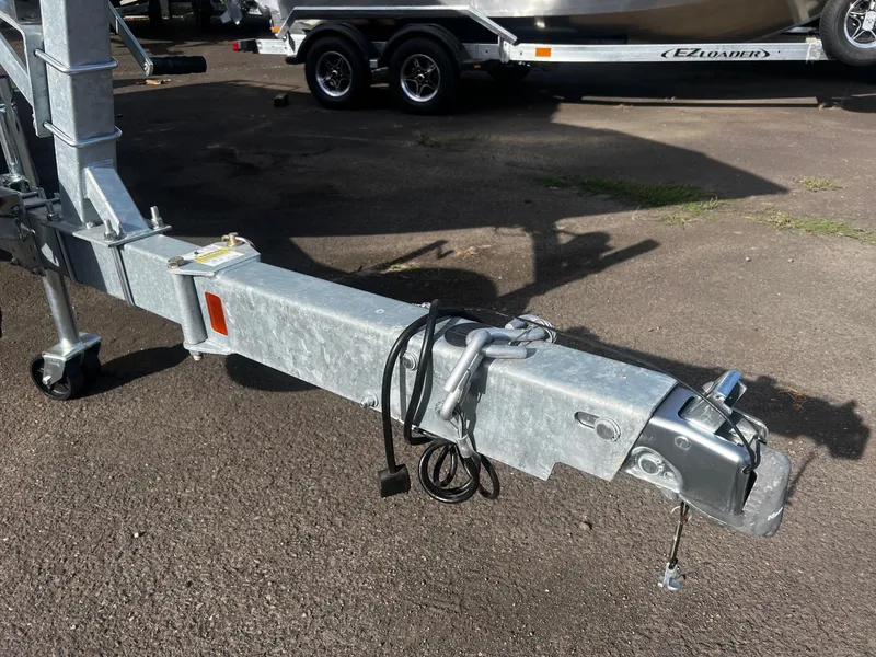 Slide: The Image of Trailer hitch of 2023 Thunder Jet 21 Chinook OS boat on pavement. - 27