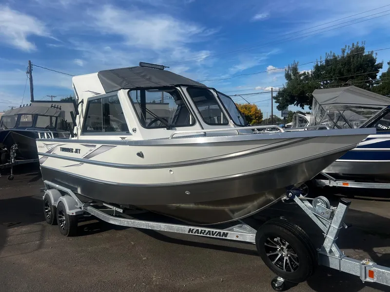 Slide: The Image of 2023 Thunder Jet 21 Chinook OS boat on a trailer under a clear blue sky. - 6