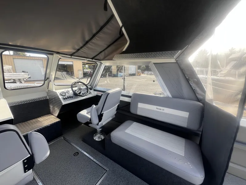 Slide: The Image of 2023 Thunder Jet 21 Chinook OS boat interior with seating and steering wheel. - 8