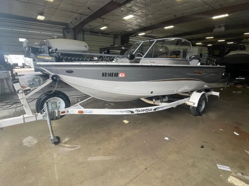 Slide: The Image of 2004 Crestliner 1700 Super Hawk boat on trailer in indoor storage. - 2