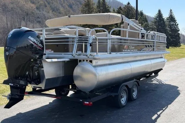 Slide: The Image of 2023 Sun Tracker SportFish 22 XP3 pontoon boat with Mercury engine on trailer. - 3