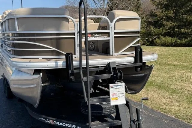 Slide: The Image of 2023 Sun Tracker SportFish 22 XP3 pontoon boat on trailer, parked outdoors. - 6