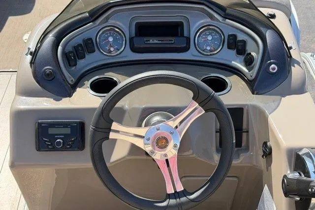 Slide: The Image of 2023 Sun Tracker SportFish 22 XP3 dashboard with steering wheel and instrument panel. - 7