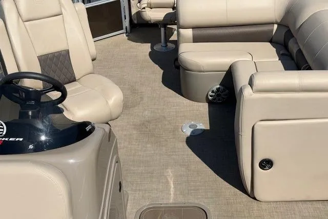 Slide: The Image of 2023 Sun Tracker SportFish 22 XP3 interior with beige seating and steering console. - 8