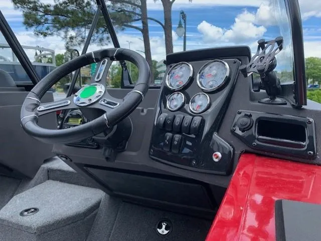 Slide: The Image of 2023 Tracker Targa V-18 WT boat dashboard with steering wheel and gauges. - 5