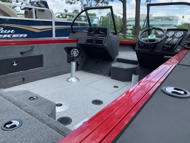Slide: The Image of 2023 Tracker Targa V-18 WT boat interior with red trim and modern dashboard. - 6