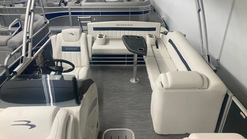 Slide: The Image of 2023 Bennington 24 LXSB pontoon boat interior with white seating and table. - 5