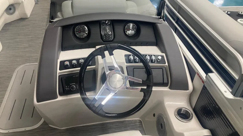 Slide: The Image of 2023 Bennington 24 LXSB boat dashboard with steering wheel and control panel. - 7