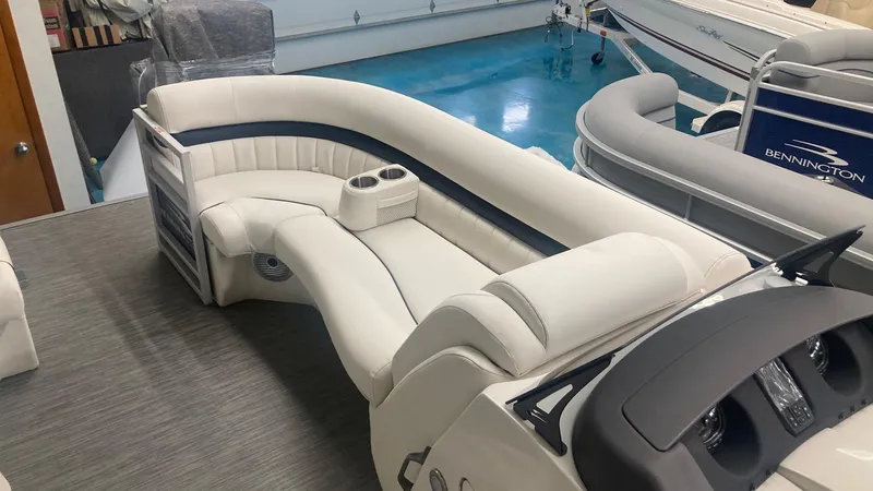 Slide: The Image of 2023 Bennington 24 LXSB pontoon boat interior with plush seating and cup holders. - 9