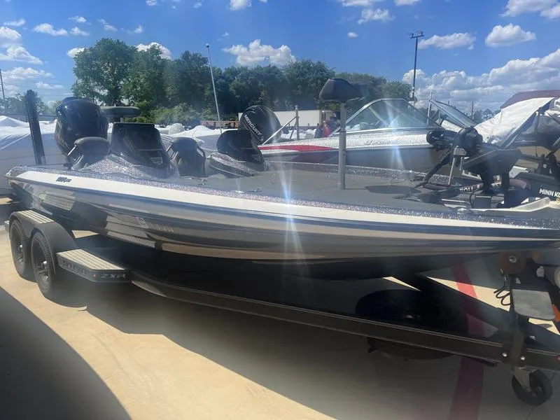 The Image of 2021 Skeeter ZXR 20 bass boat on a trailer under a sunny sky. - 1