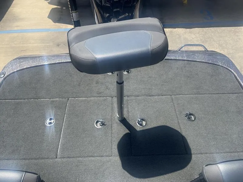 Slide: The Image of 2021 Skeeter ZXR 20 boat deck with a single seat and storage compartments. - 7