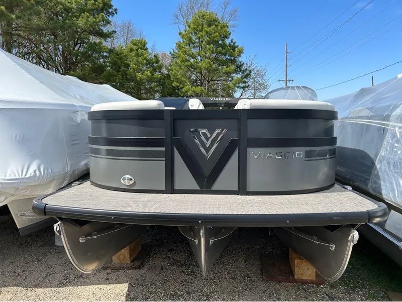 Slide: The Image of 2023 Viaggio D23U pontoon boat, docked outdoors, surrounded by trees and covered boats. - 14