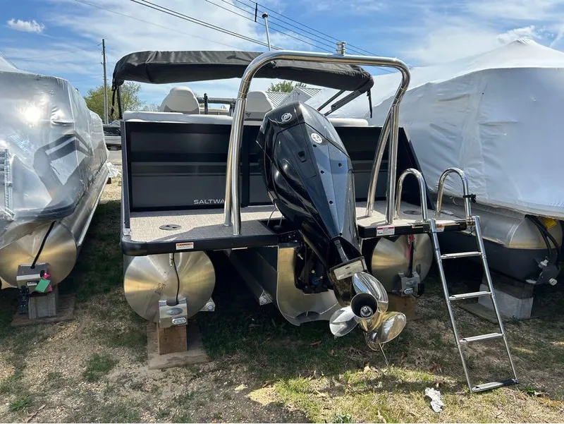 Slide: The Image of 2023 Viaggio D23U pontoon boat with outboard motor and ladder, parked outdoors. - 17