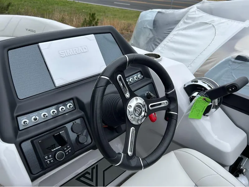 Slide: The Image of 2023 Viaggio D23U boat dashboard with steering wheel and Simrad display. - 10