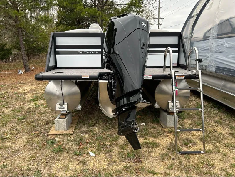 Slide: The Image of Viaggio D23U 2023 pontoon boat with outboard motor and ladder, parked on grass. - 15