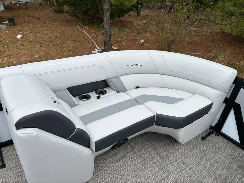 Slide: The Image of 2023 Viaggio D23U boat seating with white and gray upholstery, featuring cup holders. - 5