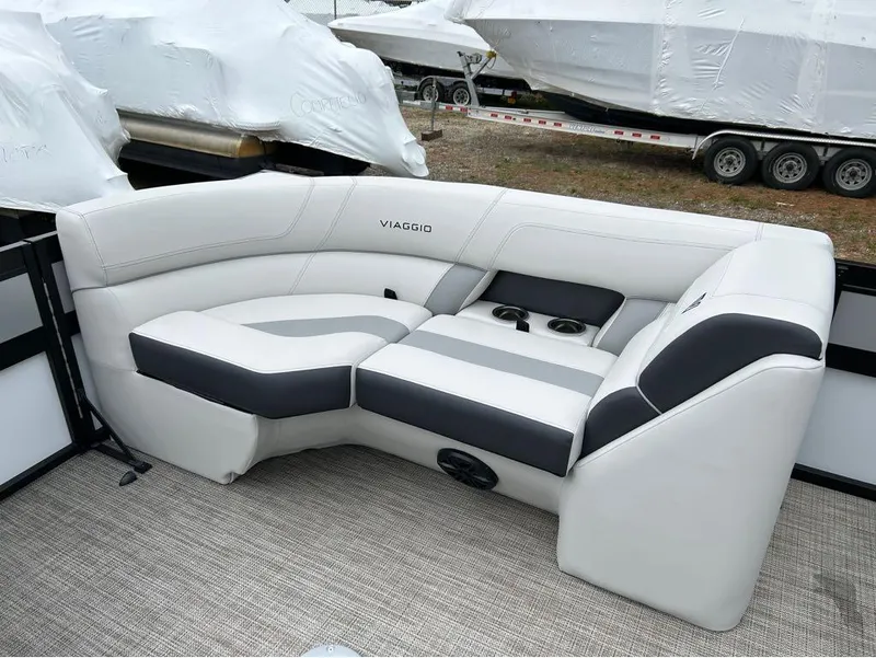 Slide: The Image of Viaggio D23U 2023 boat seating with white and gray upholstery, featuring cup holders. - 7