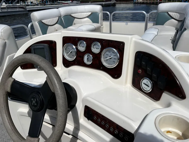 Slide: The Image of 2008 Sweetwater SW2186RE4 boat dashboard with steering wheel and gauges. - 9