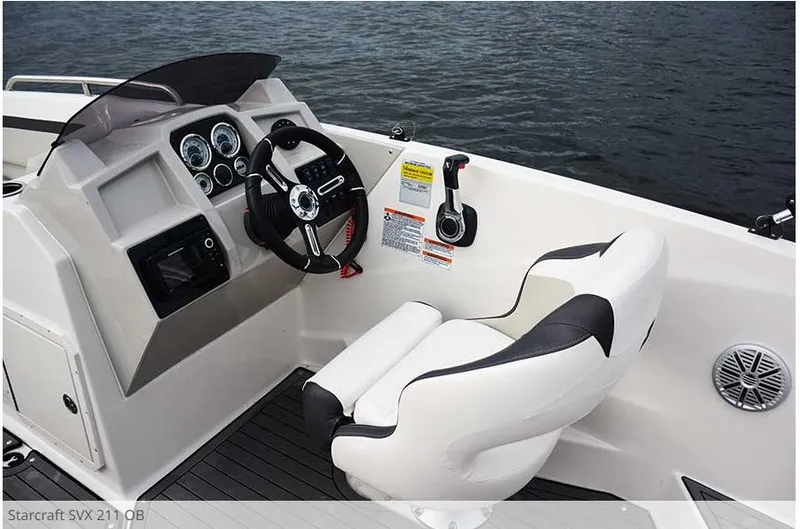 Slide: The Image of 2023 Starcraft SVX211 boat cockpit with steering wheel and controls. - 8