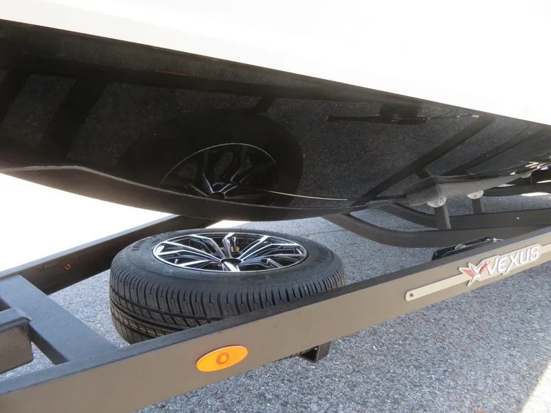Slide: The Image of 2023 Vexus VX20 boat trailer with spare tire and sleek design. - 13