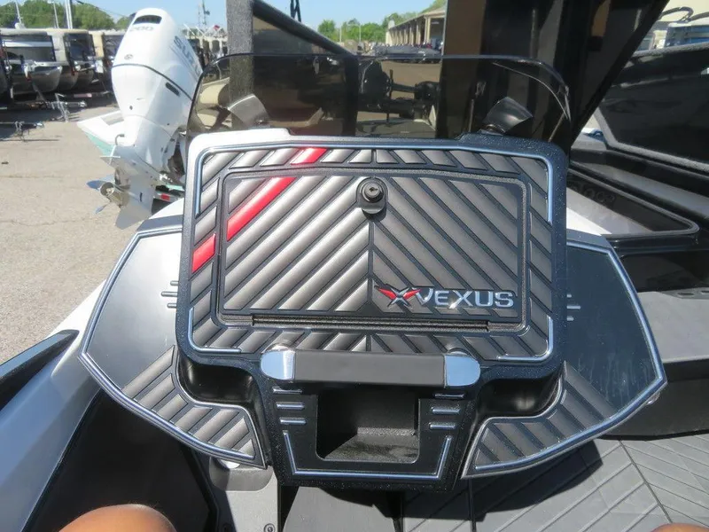 Slide: The Image of 2023 Vexus VX20 boat dashboard with storage compartment and logo. - 17