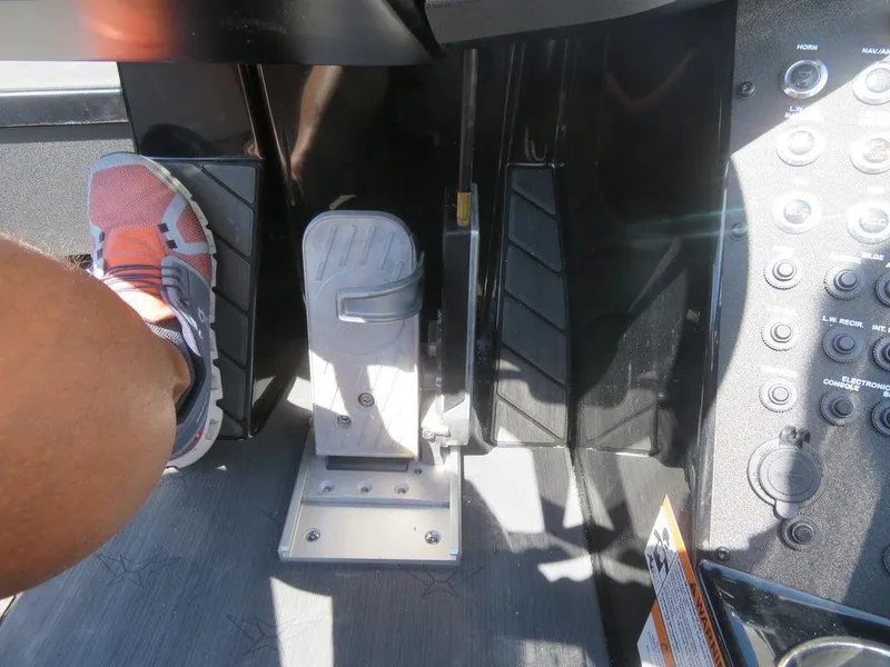 Slide: The Image of Foot pedal and control panel of a 2023 Vexus VX20 boat. - 22