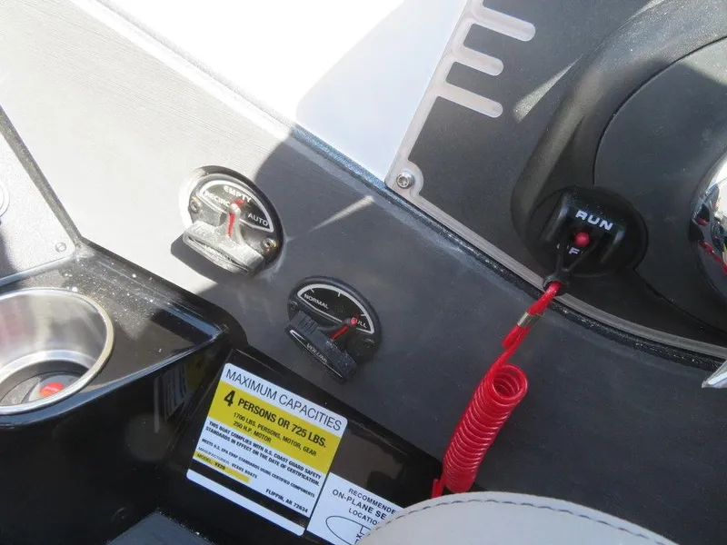 Slide: The Image of Control panel of 2023 Vexus VX20 boat with capacity label and ignition switch. - 26
