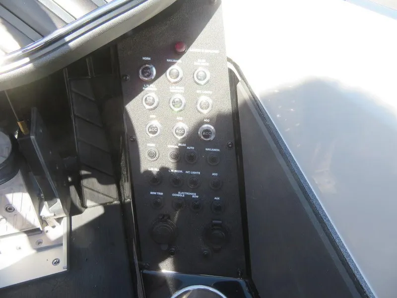 Slide: The Image of Control panel of a 2023 Vexus VX20 boat with various switches and buttons. - 31