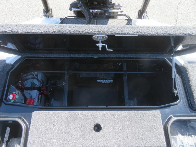 Slide: The Image of 2023 Vexus VX20 boat storage compartment with battery and wiring. - 33