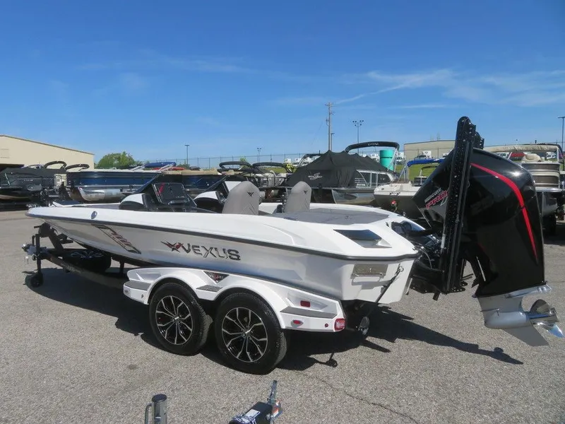 Slide: The Image of 2023 Vexus VX20 boat on a trailer in a marina parking lot. - 4
