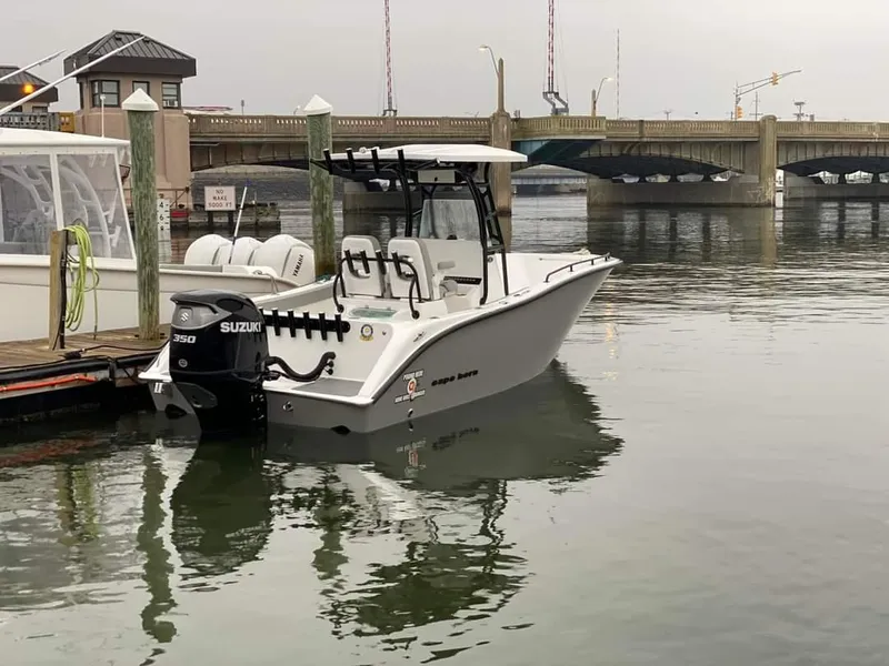 Slide: The Image of 2024 Cape Horn 22 OS boat docked with Suzuki outboard motor. - 11
