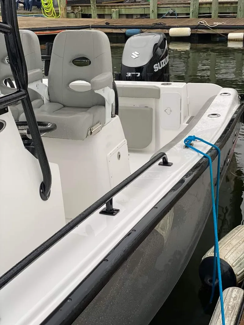 Slide: The Image of 2024 Cape Horn 22 OS boat docked, featuring Suzuki outboard motor and comfortable seating. - 9